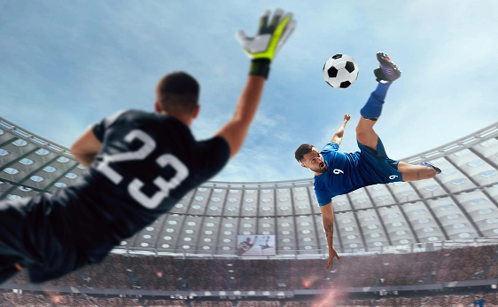 Dynamic football stadium scene capturing a player performing an acrobatic kick while the goalkeeper attempts a save.